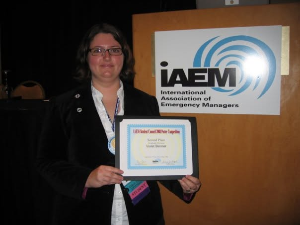 Violet receiving second place in the IAEM student poster competition